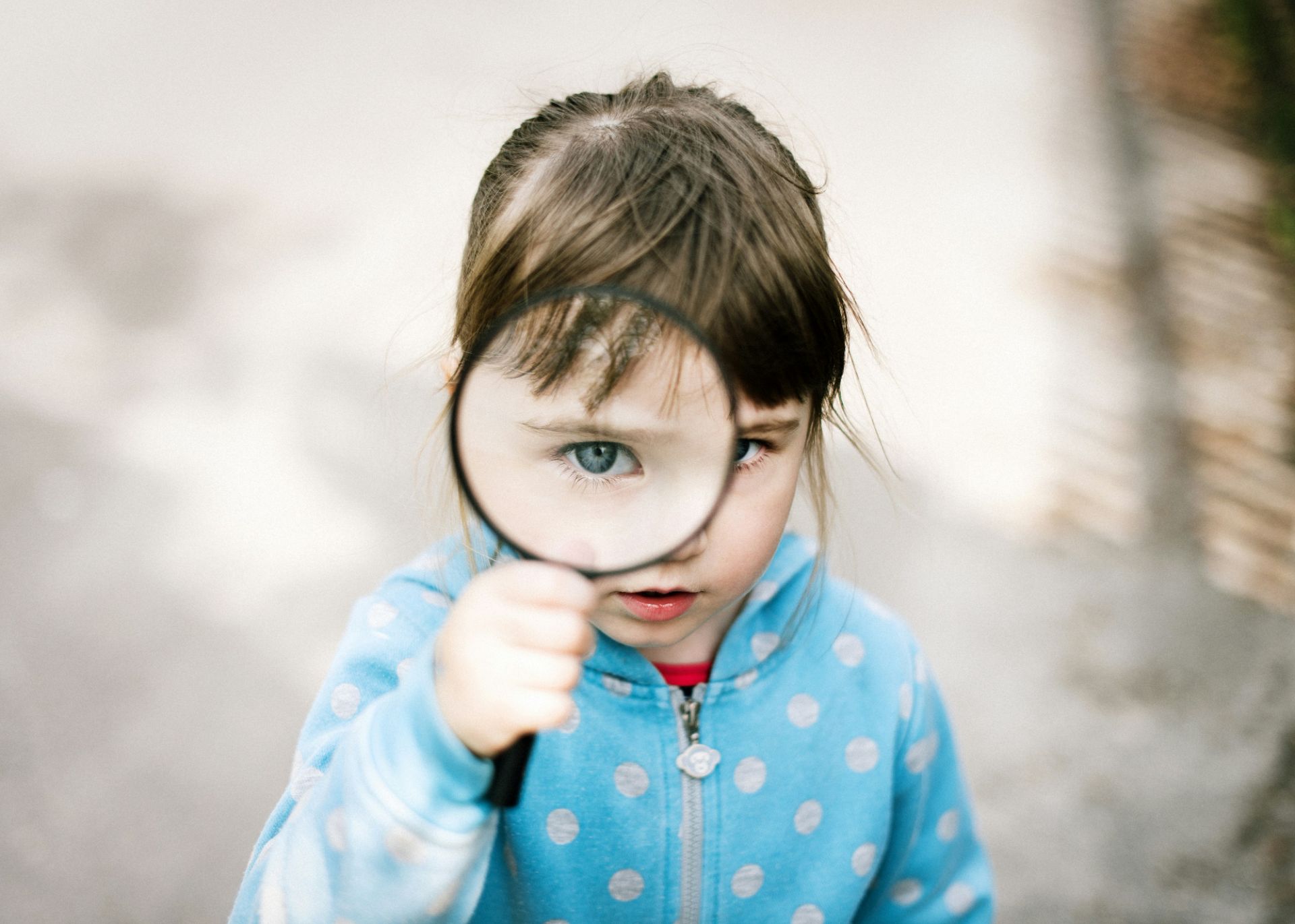 a girl viewing through magnifying glass